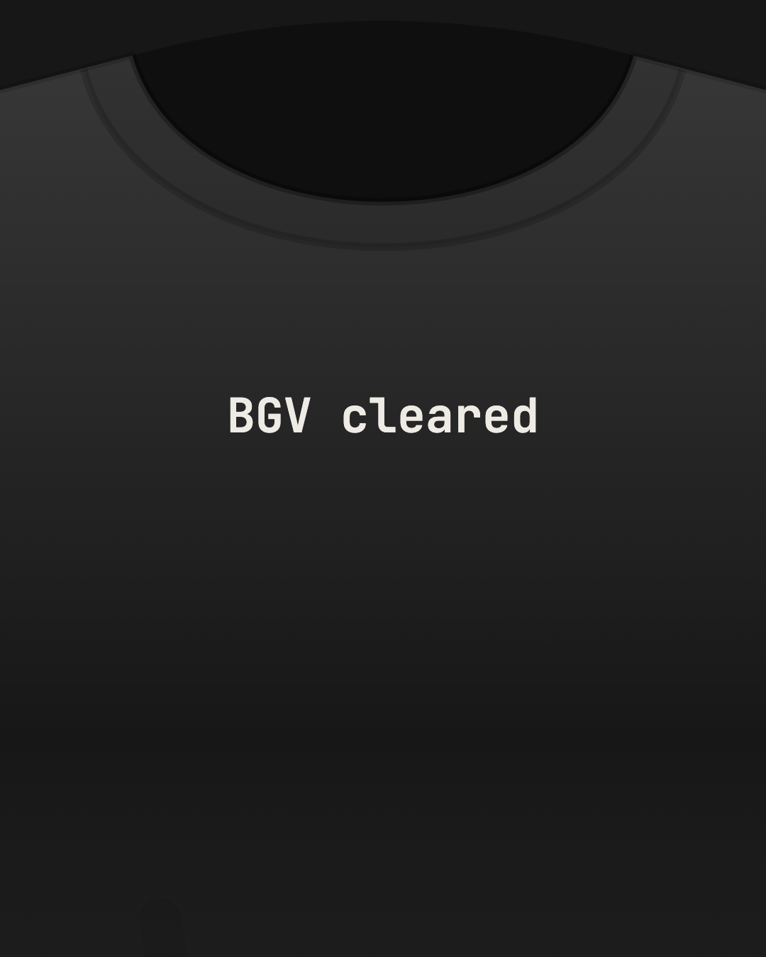 Close-up of a black tee with “BGV cleared” printed small in off-white on the chest