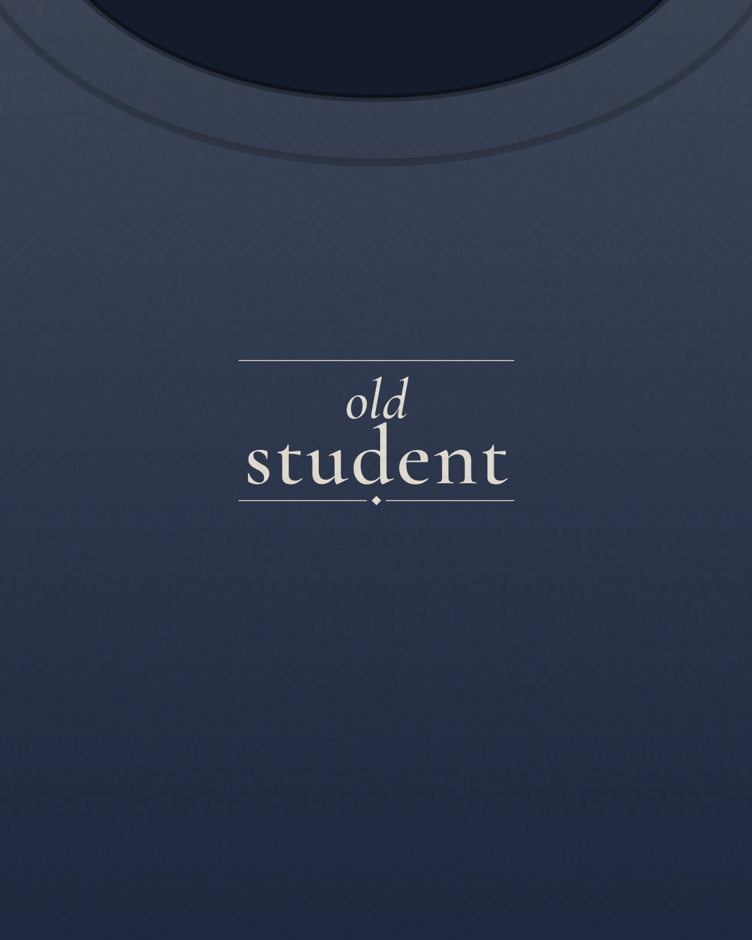 Close-up of the “old student” print in cream on a navy tee