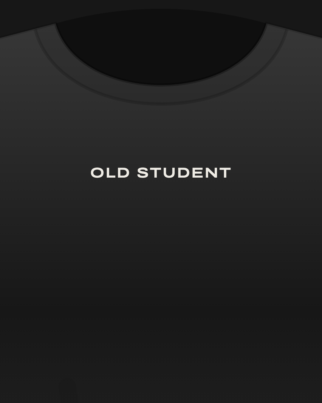Close-up of a black tee with “old student” printed small in off-white on the chest