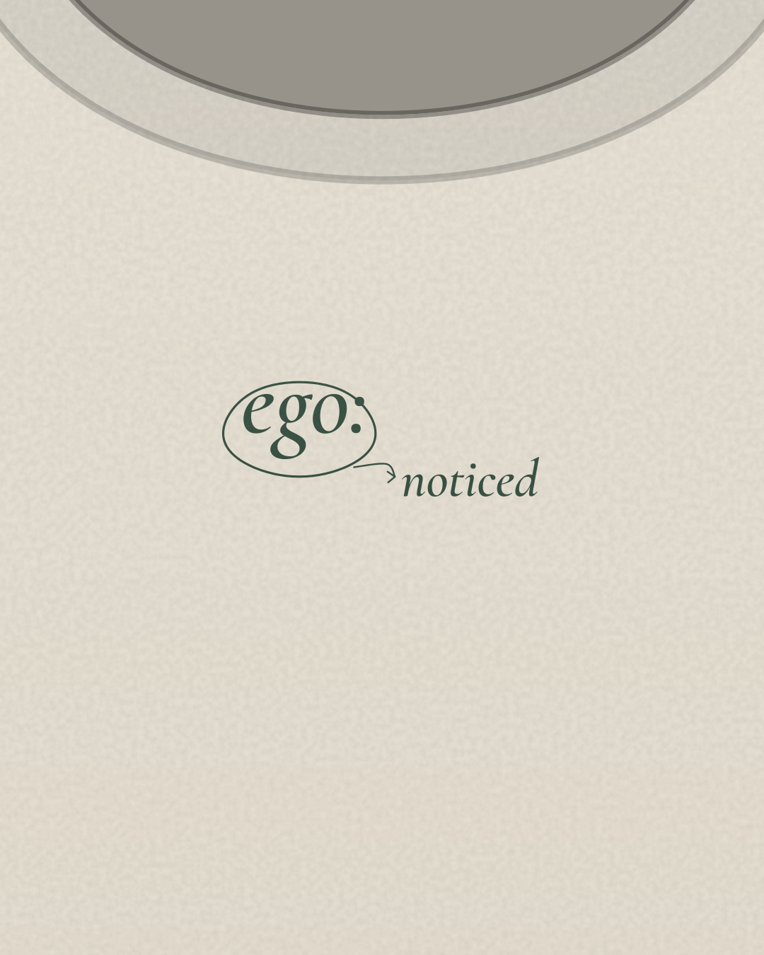 Close-up of the “ego: noticed” print in forest on a bone tee