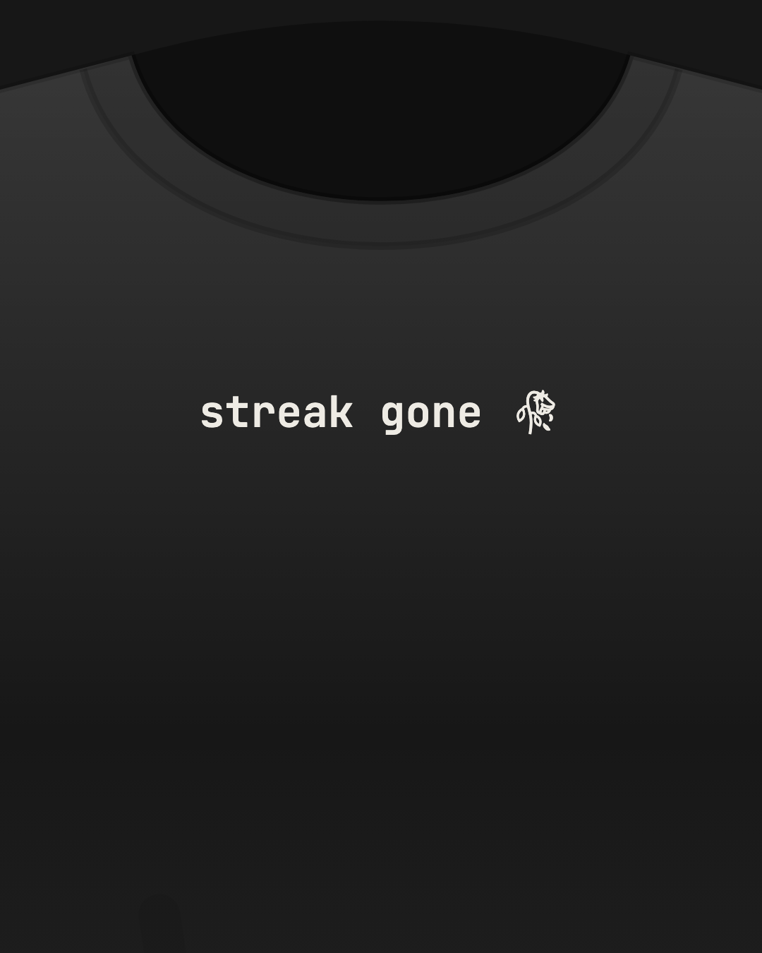 Close-up of a black tee with “streak gone 🥀” printed small in off-white on the chest