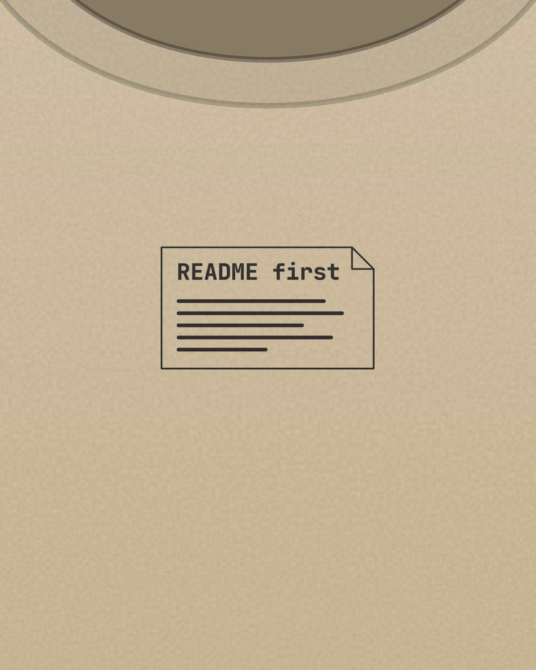 Close-up of the “README first” print in black on a sand tee