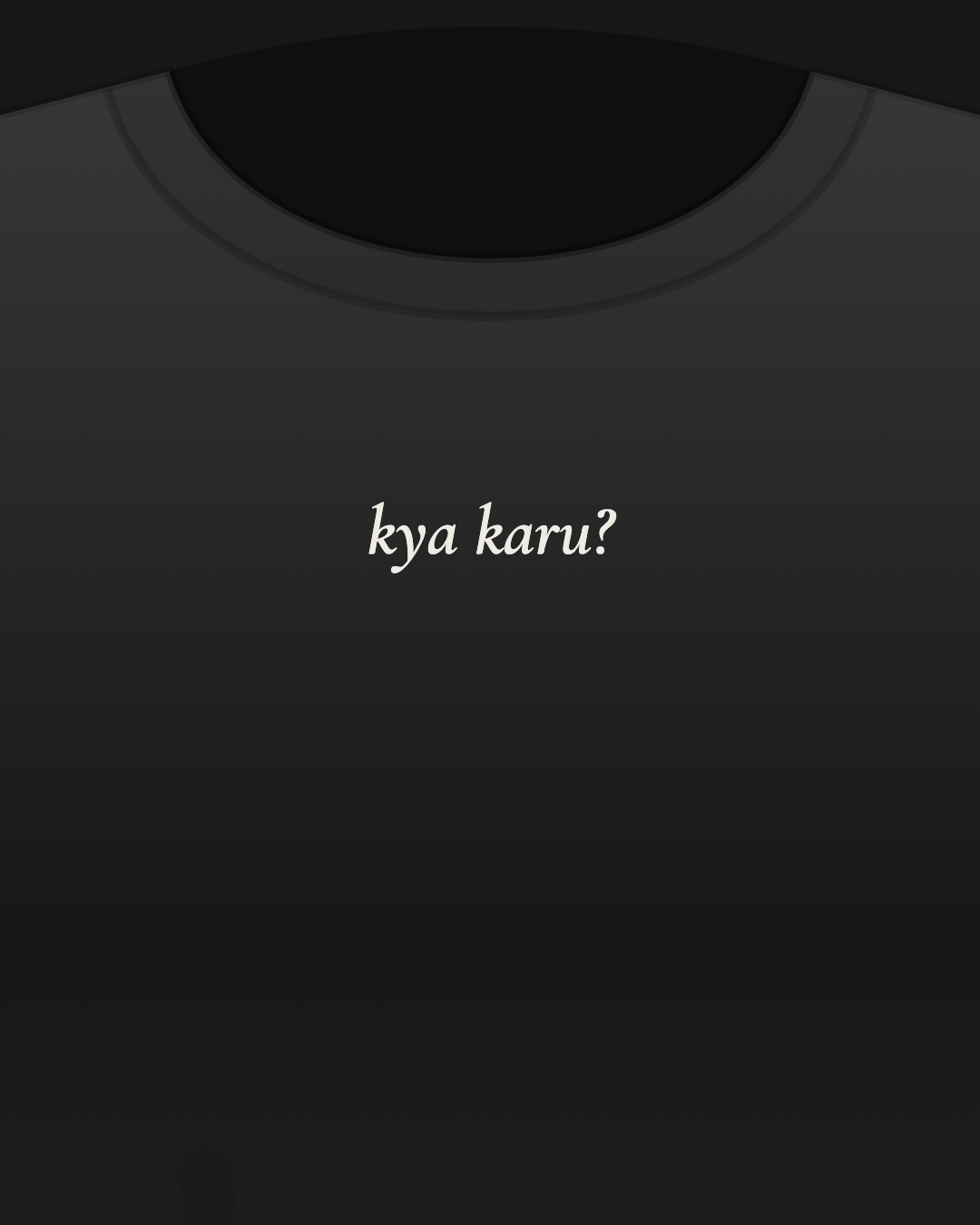 Close-up of a black tee with “kya karu?” printed small in off-white on the chest
