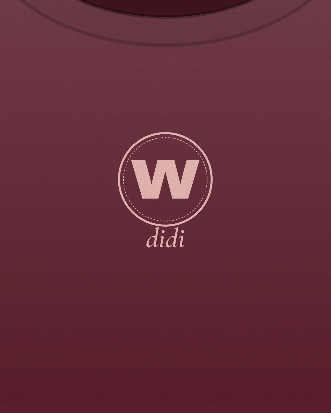Close-up of the “W didi” print in blush on a burgundy tee