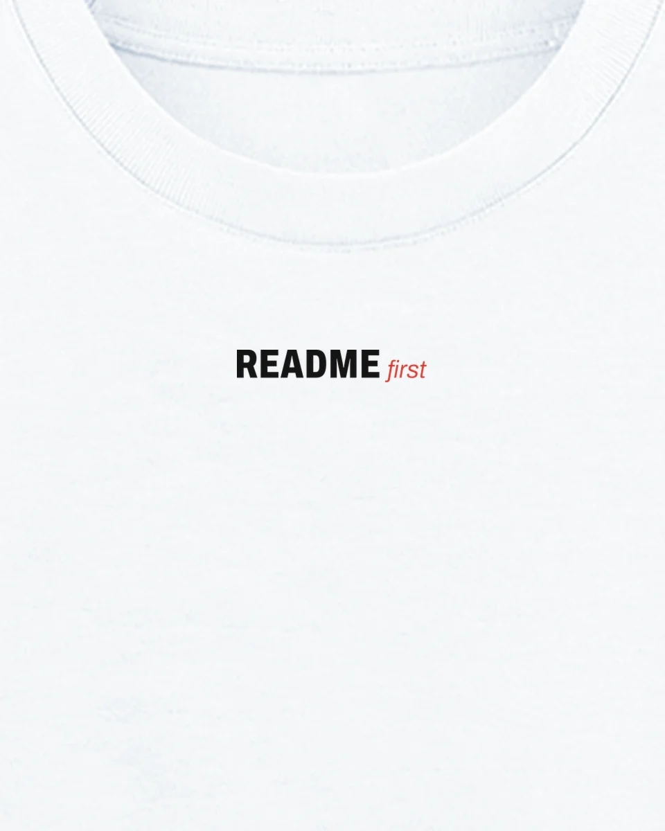 Mockup: close-up of “README first” printed on a white oversized tee