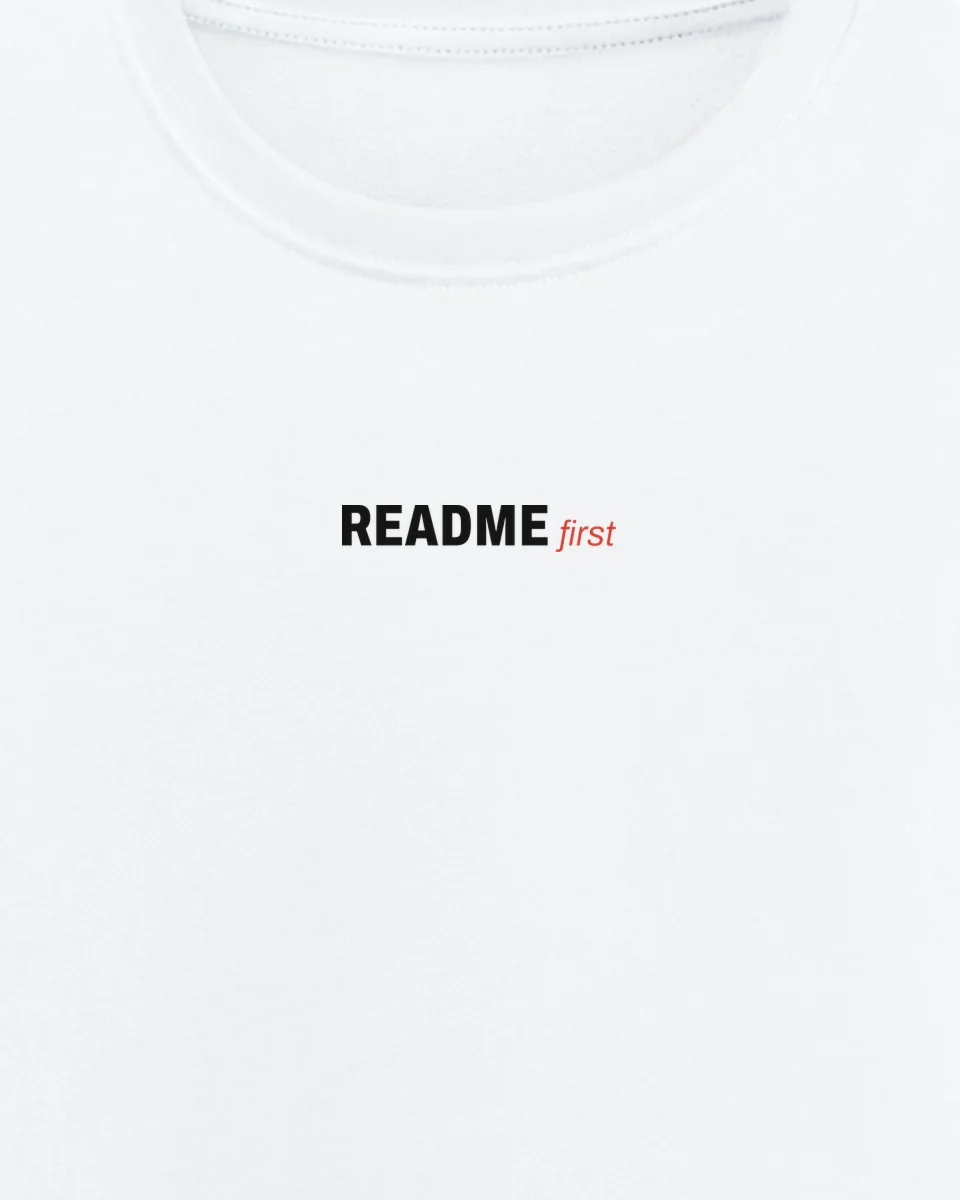 Mockup: close-up of “README first” printed on a white regular tee