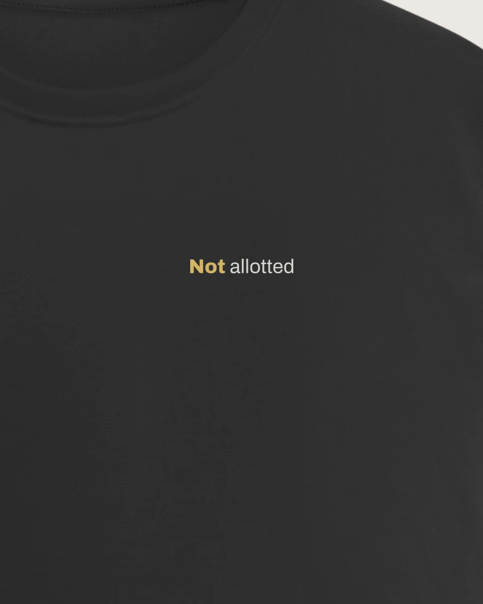 Mockup: close-up of “Not allotted” printed on a jet black regular tee