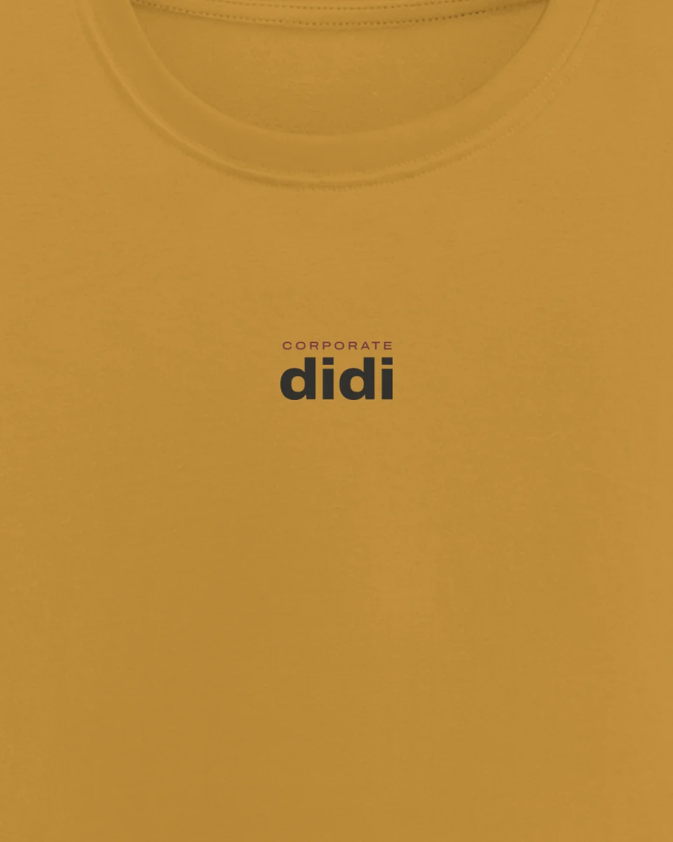 Mockup: close-up of “Corporate didi” printed on a mustard regular tee