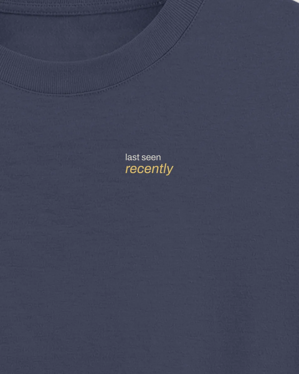 Mockup: close-up of “Last seen recently” printed on a navy oversized tee